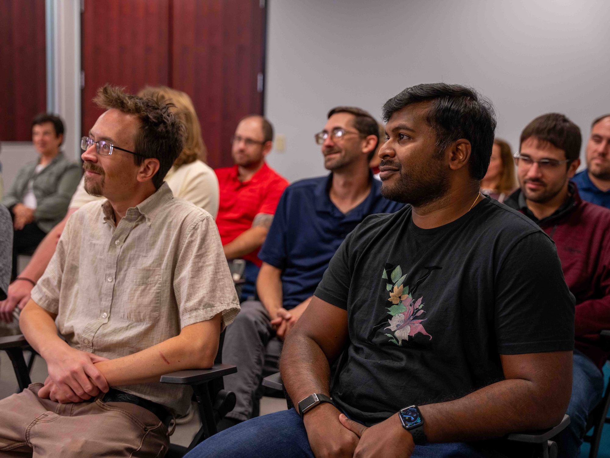 Audience members seated and attentively listening during a focus group session at Beyond the Table Research, engaging with the presentation in a collaborative learning environment.